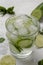 Infused water on a glass. Detox water mix of cucumber, lemon, lime and mint