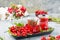 Infusion of viburnum berries in glasses and twigs with berries and viburnum leaves on a substrate on the table. Alternative