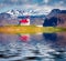 Ingjaldsholl church reflected in the calm waters of Atlantic ocean.