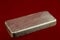 Ingot of Solid Silver on a Red Background