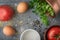 Ingredients for baked eggs with tomatoes on the stone table top view