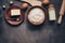 Ingredients for baking on a dark rustic background, flour, butter, eggs, rolling pin, whisk and paddle. Top view, flat lay,copy