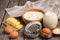 Ingredients for baking - milk, butter, eggs and flour. Rustic background.