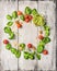 Ingredients for basil pesto on white wooden background, cirkel frame with place for text