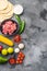 Ingredients for beef meat mexican tacos , corn tortillas, chili pepper, avocado, meat  on textured grey background, top view