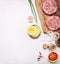 Ingredients for a burger, onion leaves, tomato sauce, onion rings, pineapple border , place text on wooden rustic background t