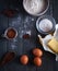 Ingredients for chocolate brownies on dark background, top view