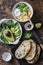 Ingredients for cooking avocado, spinach, egg salad on toast sandwich. Healthy food breakfast, snack on wooden background, top vie