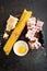 Ingredients for cooking Carbonara pasta, spaghetti with pancetta, egg and hard parmesan cheese. Traditional italian cuisine. Pasta