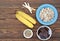 Ingredients for cooking frozen bananas in chocolate on wooden background