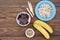 Ingredients for cooking frozen bananas in chocolate on wooden background