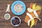 Ingredients for cooking frozen bananas in chocolate on wooden background