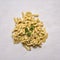 Ingredients for cooking handful pasta on the table with leaf parsley on wooden rustic background top view