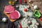 Ingredients for cooking healthy meat dinner. Raw uncooked beef rib eye steaks with mushrooms, rice, herbs and spices on table back