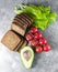 Ingredients for cooking homemade vegan hamburgers. avocado, tomato, green sprouts, black bread, salad