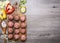 Ingredients for cooking meat balls with herbs and onions on a cutting board with tomatoes, peppers, zucchini and herbs on wooden r