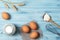Ingredients for cooking, milk, eggs, wheat flour and kitchenware on blue wooden background, top view