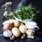 Ingredients for cooking potato soup with garlic, rukola, onions