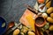 Ingredients for cooking: potatoes, salt, pepper, onion, garlic on a dark stone table.