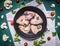 Ingredients for cooking raw chicken wings lined circle in the old cast-iron frying pan a white napkin Cauliflower tomatoes