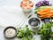 Ingredients for cooking spring rolls - carrots, cucumbers, herbs, red cabbage, shrimps, rice paper on a gray background. Food set