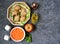 Ingredients for cooking vegetable salad: raw Jerusalem artichoke in wicker basket, raw grated carrots, apple, olive oil, red wine
