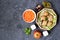 Ingredients for cooking vegetable salad: raw Jerusalem artichoke in wicker basket, raw grated carrots, apple, olive oil, red wine