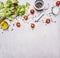 Ingredients for cooking Vegetarian Food, lettuce, cherry tomatoes, oil, salt and pepper wooden rustic background top view close