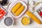 Ingredients for corn soup or stew: ear of corn, canned and cooked corn , seasoning and vegetables broth on white wooden background