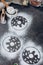 Ingredients for donuts baking. Spoon with flour, dishes, eggs, sugar on a grey background.