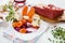 Ingredients for French meat dish Boeuf Bourguignon in a white bowl.