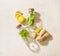 Ingredients for ginger lemon mint lemonade. Glass bottles with mint leaves on white background with sliced lemon and ginger. Top