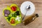 Ingredients for greek salad on cutting board, bowl, spoon, oil