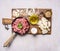 Ingredients for hamburgers, minced meat in a frying pan with pepper and onion rings cutting board on wooden rustic background