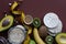 Ingredients for healthy breakfast. Fruits, oatmeal, nuts, avocado, crisp breads, on brown background.