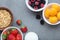 Ingredients for healthy breakfast meal: raspberries, blackberries, strawberries, apricot, granola, milk. Fruit frame