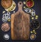 Ingredients for homemade burger with tuna, laid out around a cutting board on wooden rustic background top view border, place for