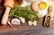 ingredients for homemade pasta on wooden table on brown background