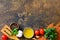 Ingredients for italy cuisine. Tomato spaghetti, herbs spices, olive oil and vegetables on a wooden table.