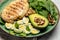 Ingredients for a ketogenic diet avocado, grilled chicken fillet, quail egg, spinach, walnut. Healthy fats, clean eating for