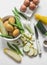 Ingredients for making frittata - potatoes, zucchini, eggs on a light background, top view