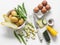 Ingredients for making frittata - potatoes, zucchini, eggs on a light background, top view