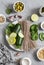 Ingredients for making green soba bowl - zucchini, spinach, soba on grey background, top view. Healthy vegetarian food concept.