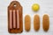 Ingredients for making hot dogs: sausages on wooden board, hot-dog buns and mustard on white wooden background, top view. Flat lay