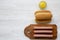 Ingredients for making hot dogs: sausages on wooden board, hot-dog buns and mustard on white wooden surface, overhead view. Flat l