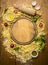 Ingredients for making pasta, Flour, eggs, rolling pin, herb,olive oil, around cutting board on wooden rustic background top view