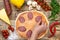 Ingredients for making pizza, before baking, on a wooden table, top view of the hand laid out sausage, step-by-step recipe