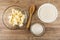 Ingredients margarine, wheat flour, sugar in bowls for cooking cookie, spoon on table. Top view