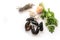 Ingredients for a Mediterranean meal with fresh blue mussels, onion, garlic, parsley and dried herb bouquet, white background with