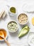 Ingredients for moisturizing, nourishing, anti-aging wrinkle face mask - avocado, olive oil, oatmeal, natural yogurt on light back